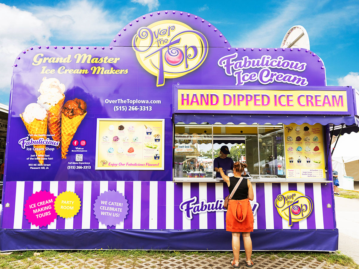 The Over The Top Ice Cream trailer at the Iowa State Fair, serving fabulicious ice cream to fairgoers at their bright purple counter.
