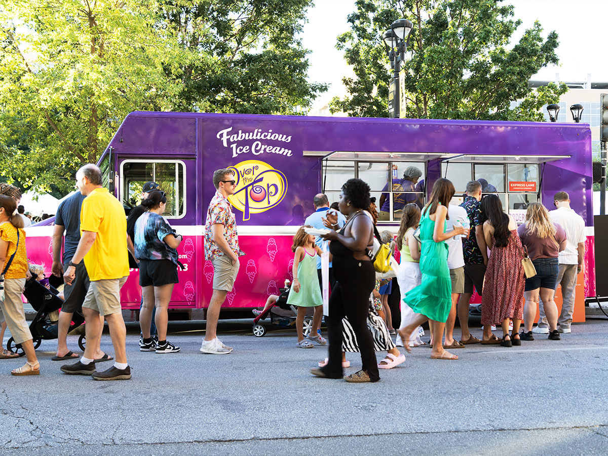 The new Over The Top Ice Cream truck at the Des Moines Arts Festival, surrounded by happy customers.