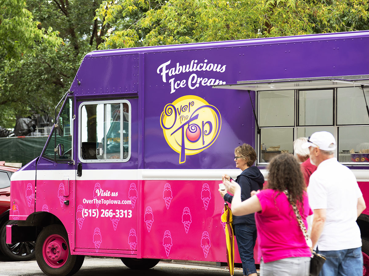 The new Over The Top Ice Cream truck at the Des Moines Arts Festival, featuring a bright pink and purple wrap.